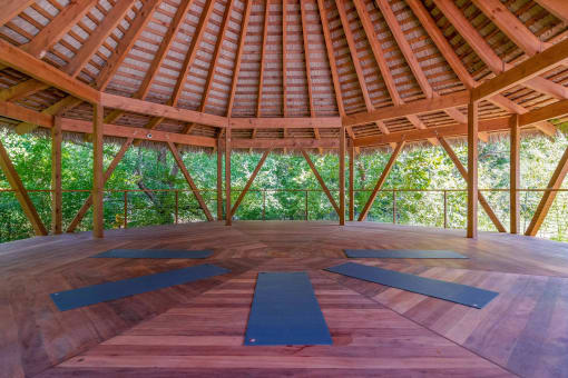 Affinitee at Pine Lake apartment a yoga room with yoga mats on the floor and trees in the background