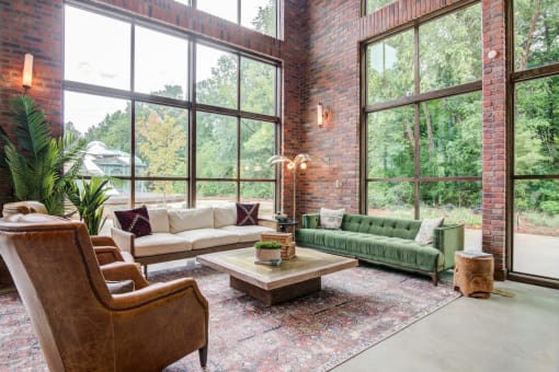 Affinitee at Pine Lake apartment a living room with large windows and a green couch