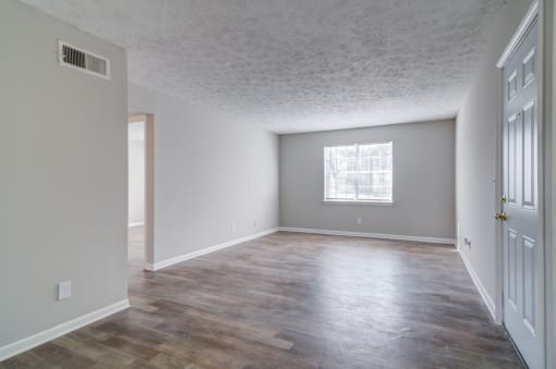 Affinitee at Pine Lake apartment the living room and dining room of an empty house
