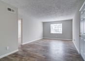 Thumbnail 6 of 12 - Affinitee at Pine Lake apartment the living room and dining room of an empty house